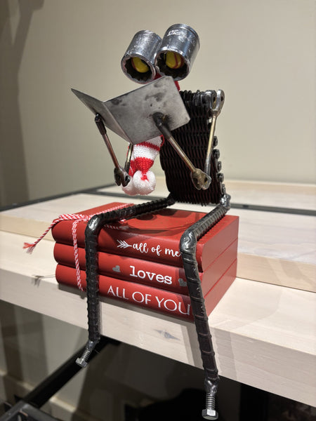 All of Me Love Story Bot by R. Nelson features a reading robot sitting on stack of books.